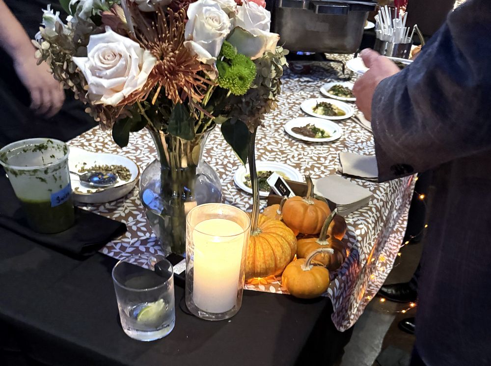 Candlelit table with roses and small pumpkins